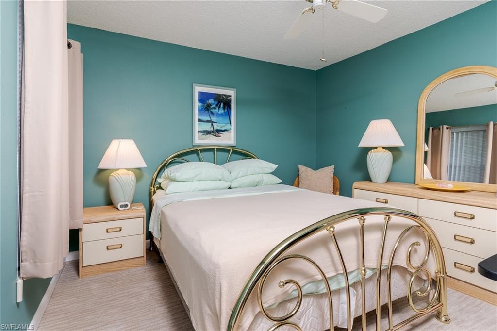 Bedroom featuring ceiling fan & walk-in closet