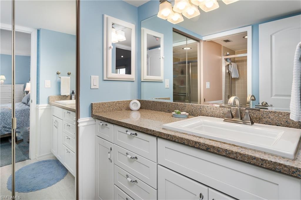 Bathroom with walk in closet and vanity