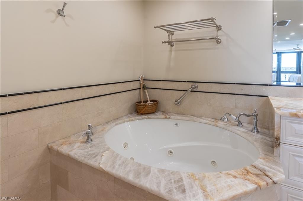 Primary Bathroom with a relaxing tiled tub