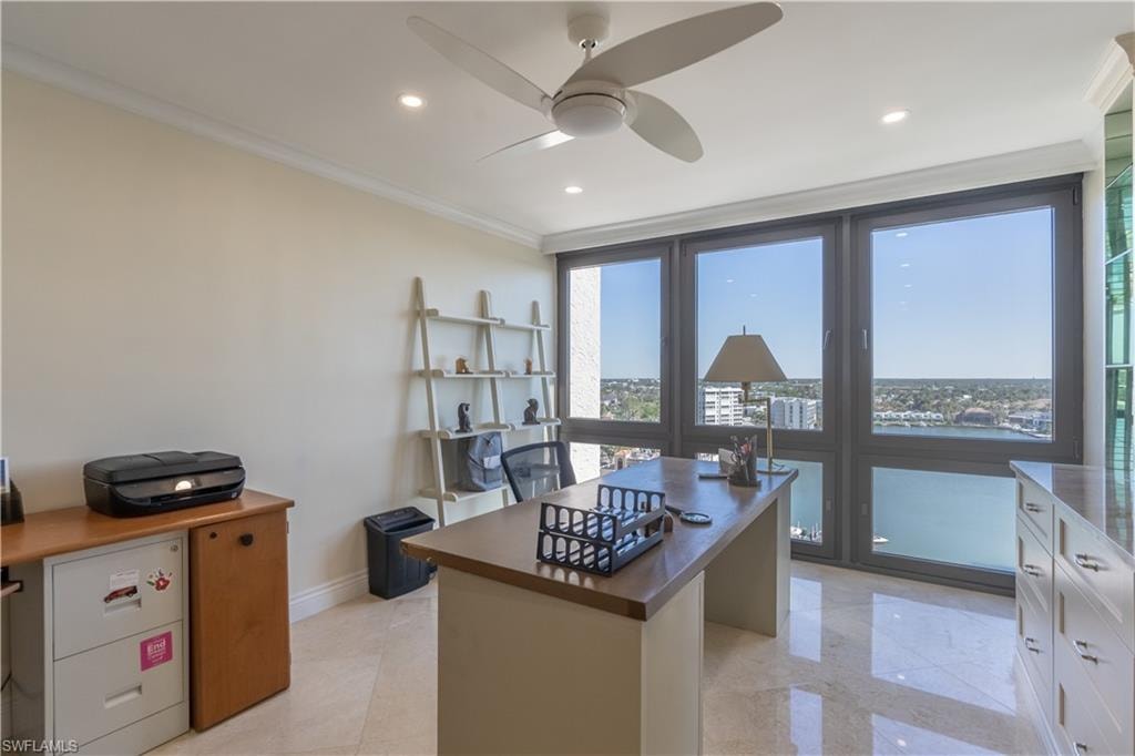 Office area featuring ceiling fan, ornamental molding, and a wealth of natural light
