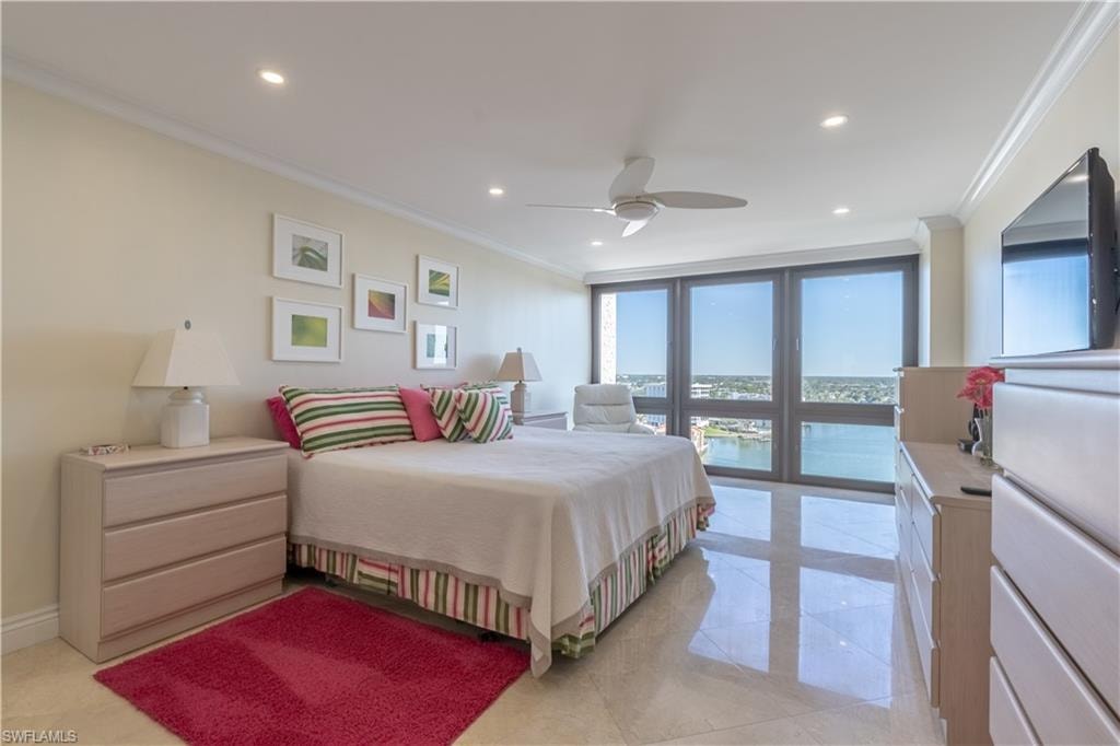 Primary bedroom with ceiling fan, access to exterior, and ornamental molding