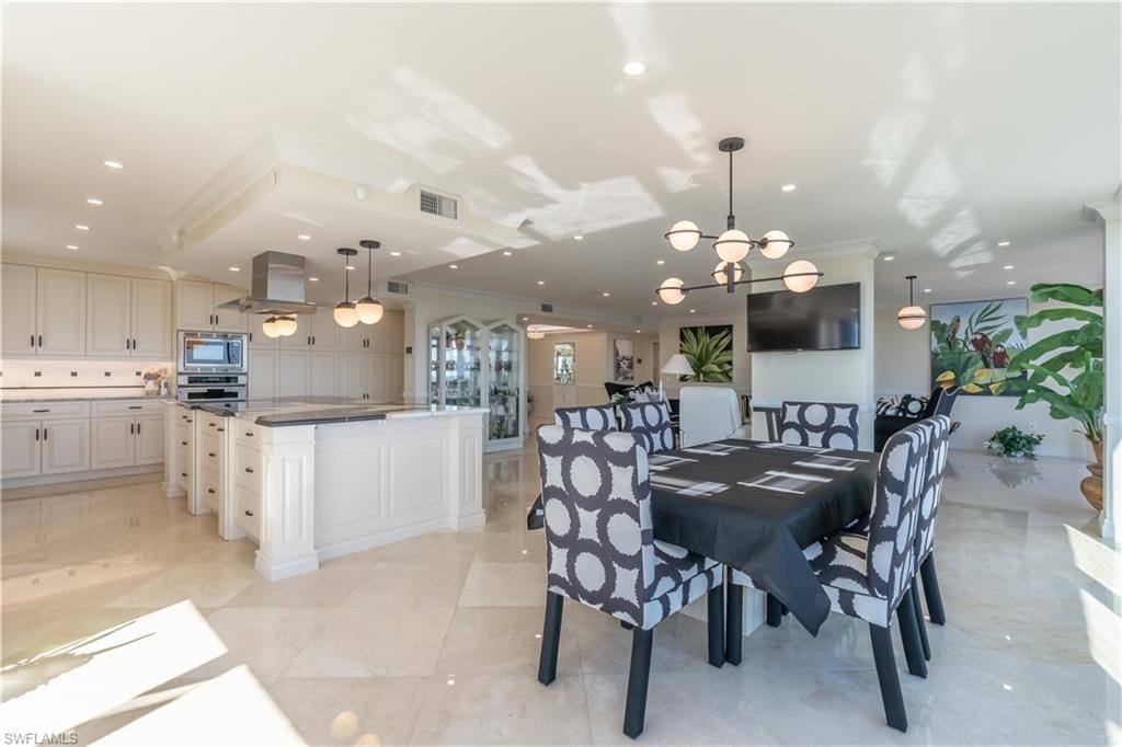 Dining area featuring a chandelier and crown molding