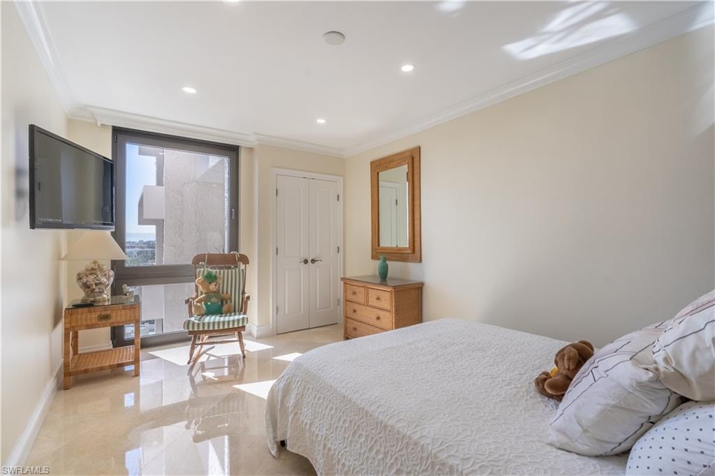 Bedroom featuring a closet and crown molding