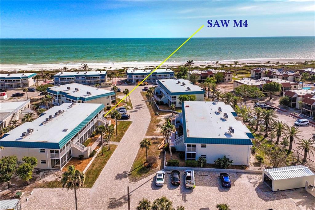 Aerial view featuring a beach view and a water view
