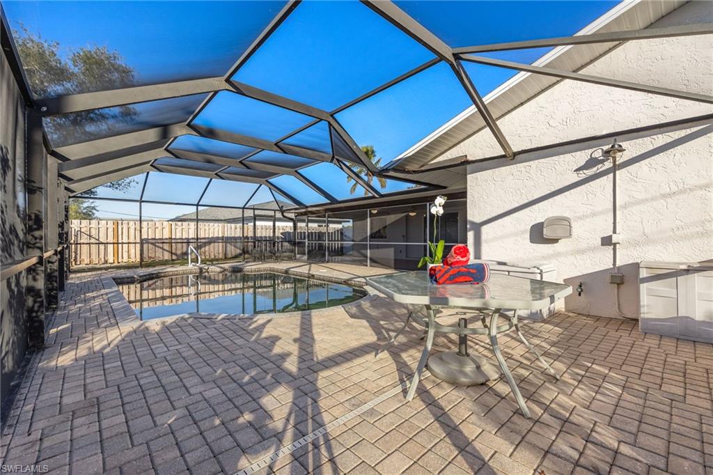 View of pool with a lanai and a patio area