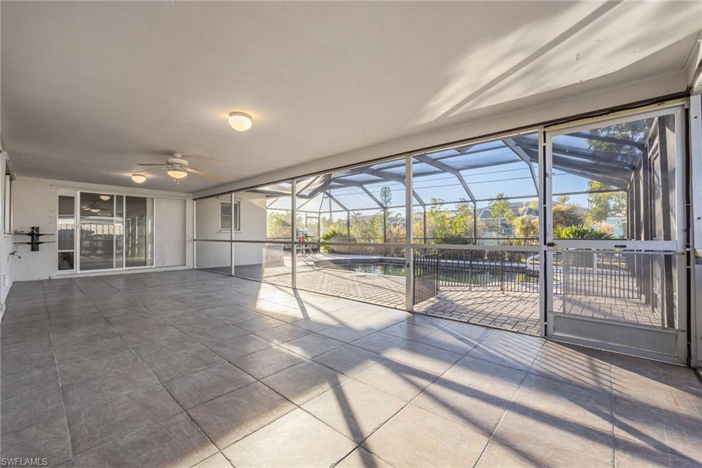 Unfurnished sunroom featuring ceiling fan