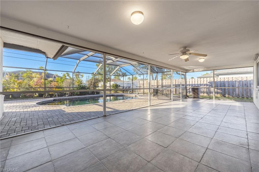 Unfurnished sunroom featuring ceiling fan