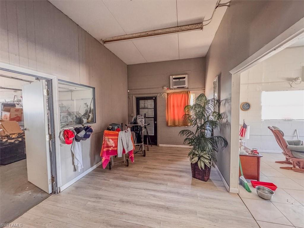 Hall featuring a wall mounted air conditioner and light wood-type flooring
