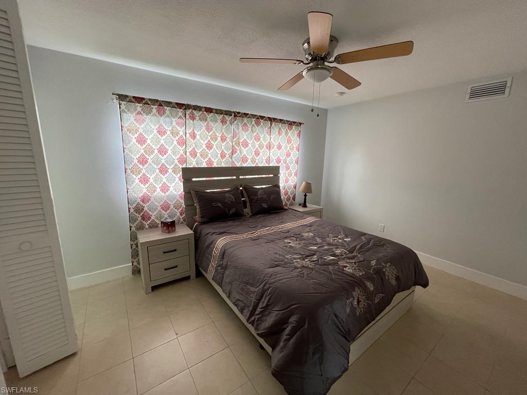 Tiled bedroom with ceiling fan