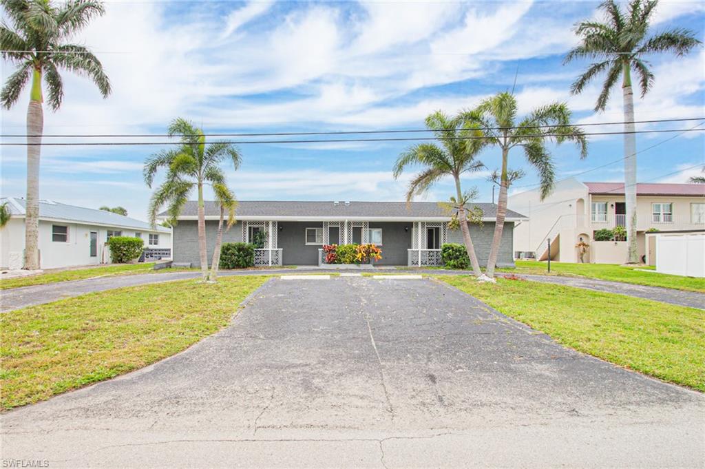 Single story home featuring a front lawn
