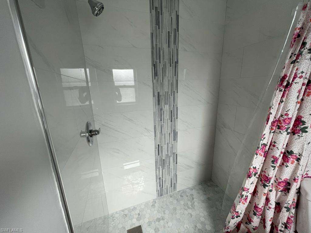Bathroom featuring curtained shower