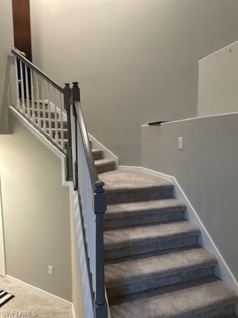 Staircase featuring tile patterned flooring