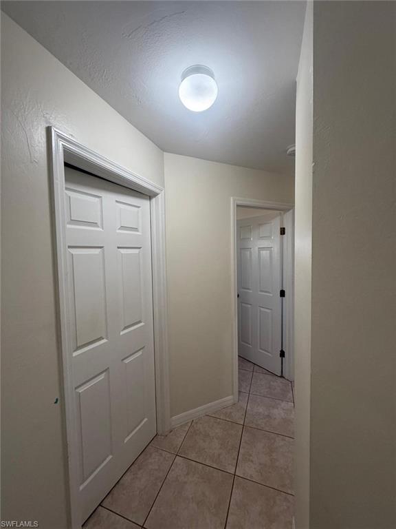 Hall with light tile patterned floors
