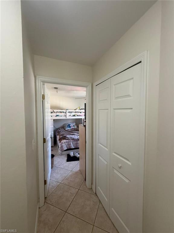 Hallway with light tile patterned floors