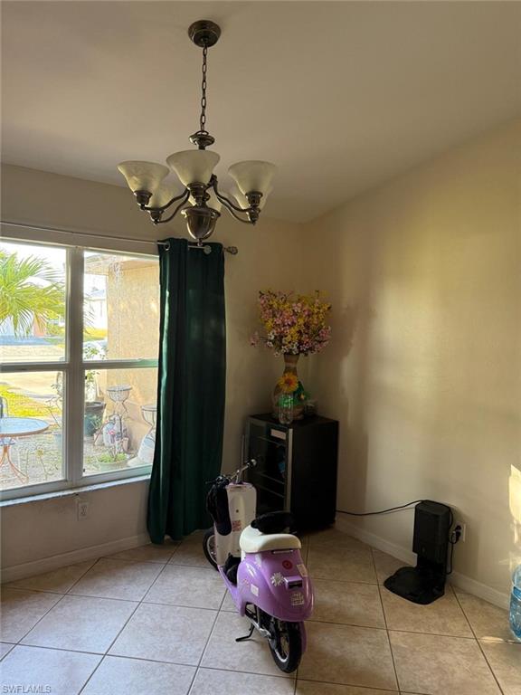 Tiled dining area with an inviting chandelier