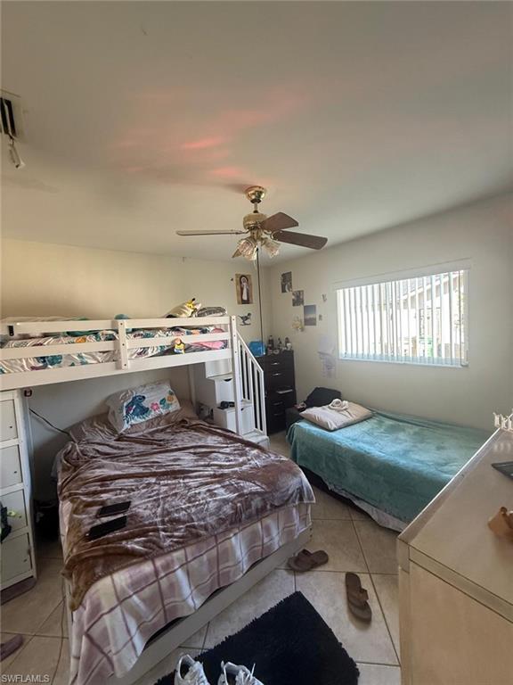 Tiled bedroom with ceiling fan