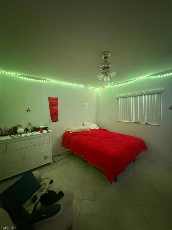 Tiled bedroom with ceiling fan