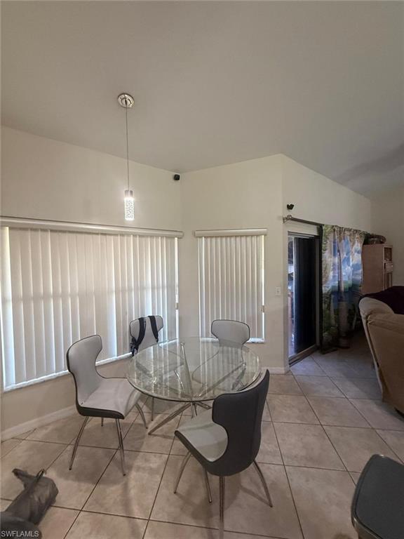 Dining area featuring light tile patterned flooring