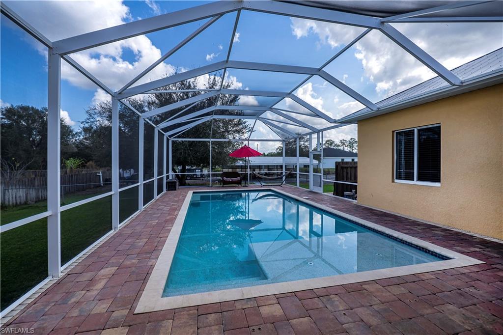View of swimming pool with a lanai and a patio area