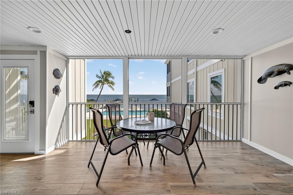 Sunroom / solarium with a water view and healthy amount of natural light