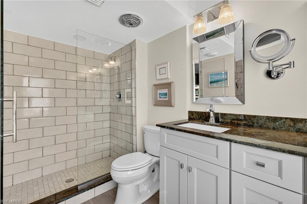 Full bath featuring vanity and a tile shower