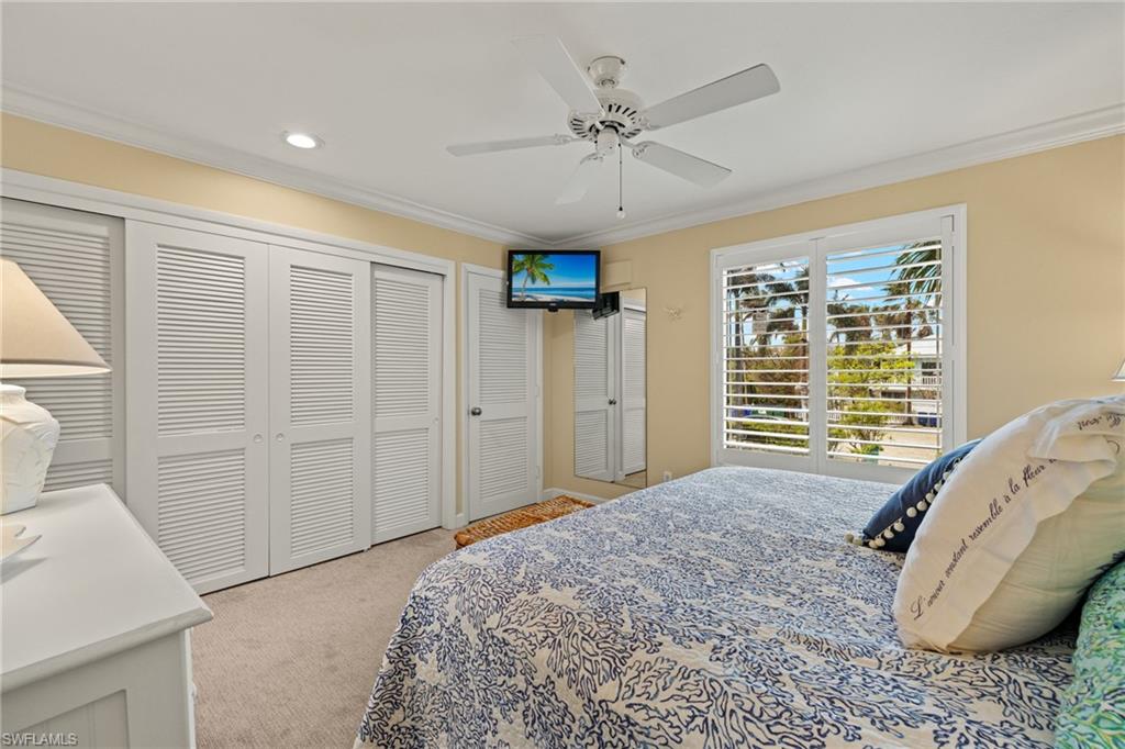 Bedroom featuring crown molding, light colored carpet, a closet, ceiling fan, and recessed lighting
