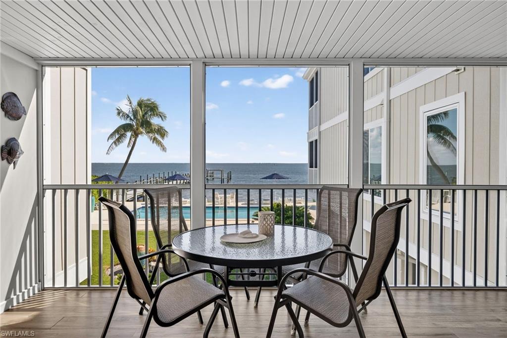 Sunroom featuring a water view and healthy amount of natural light