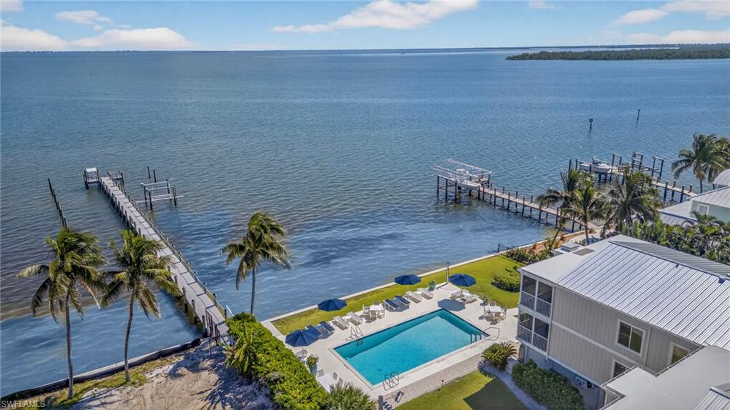 Aerial view of a pool area and a nearby body of water