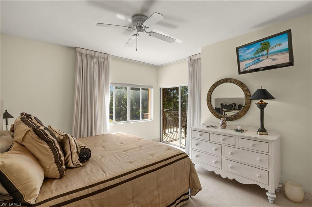 Guest bedroom featuring access to exterior and ceiling fan