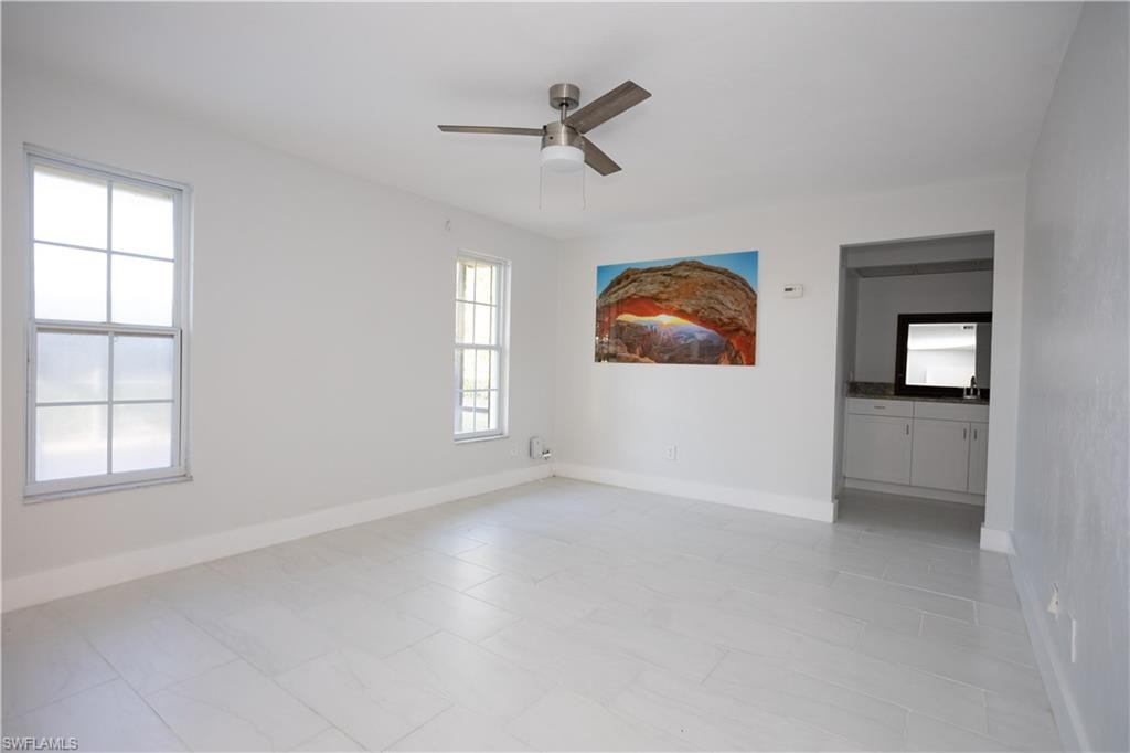 Empty room featuring sink and ceiling fan