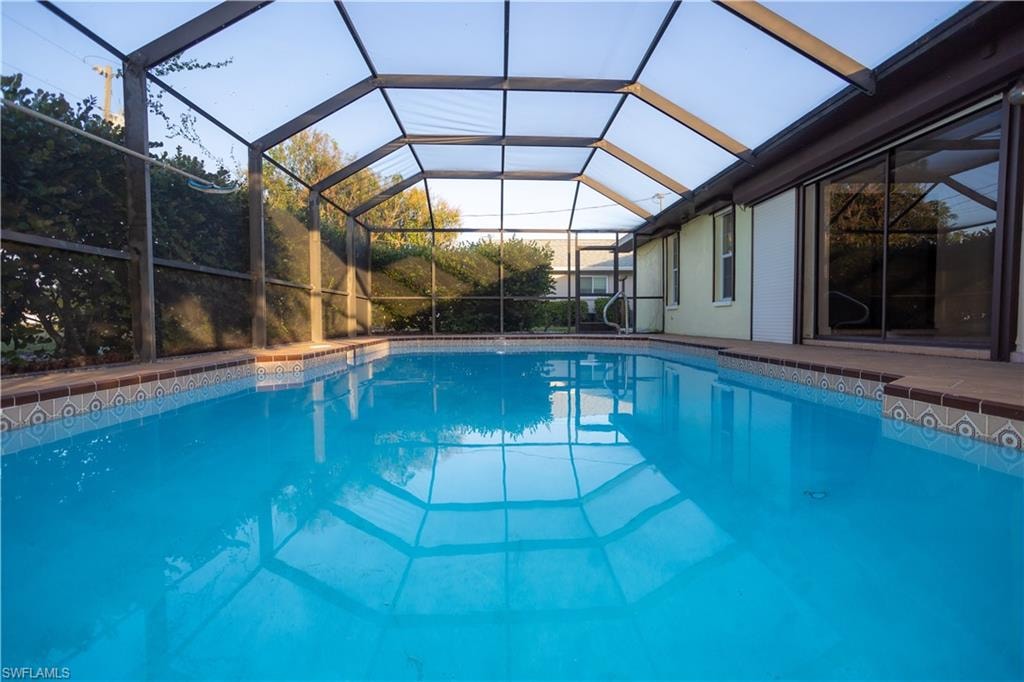 View of pool featuring glass enclosure