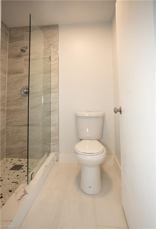 Bathroom featuring toilet and tiled shower