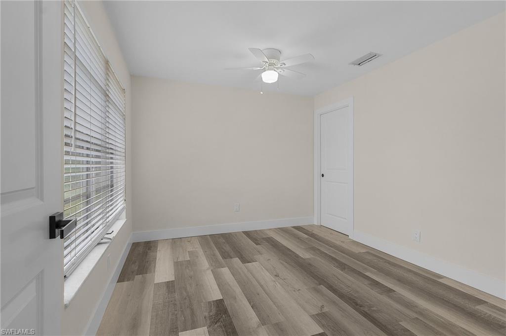 Unfurnished room with ceiling fan and light hardwood / wood-style flooring