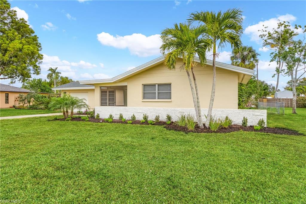 View of property exterior featuring a lawn