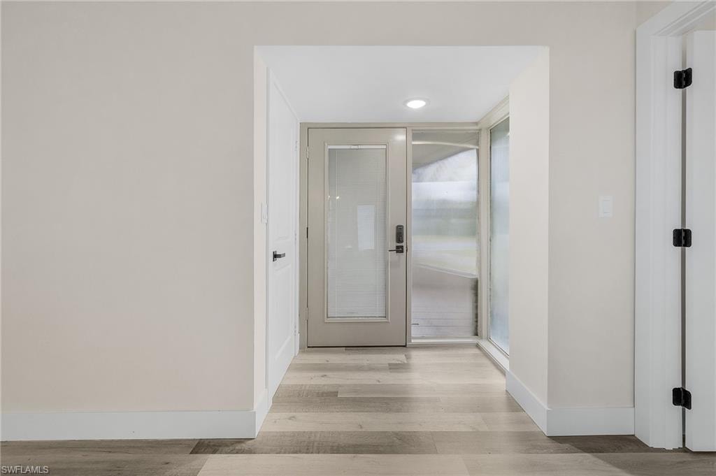 Hall with light hardwood / wood-style flooring