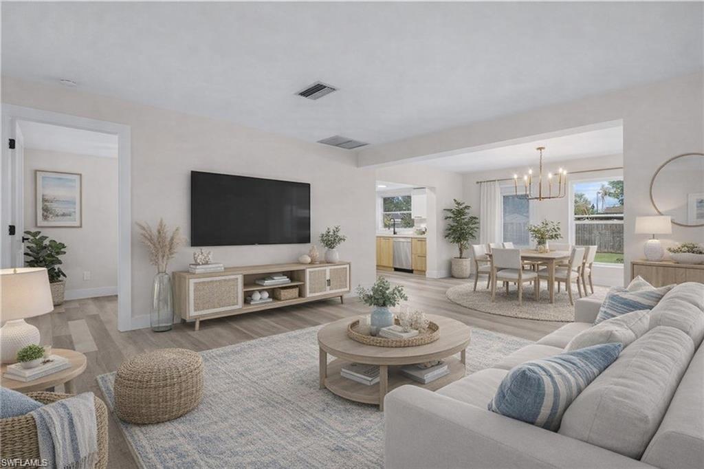 Living area featuring wood look vinyl floors. (virtually Staged)