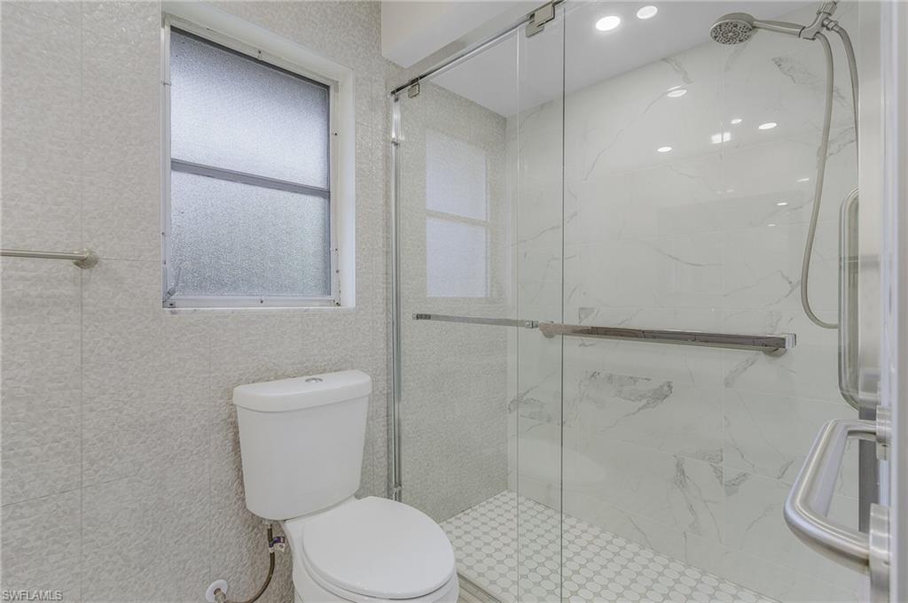 Bathroom with a shower with door and toilet