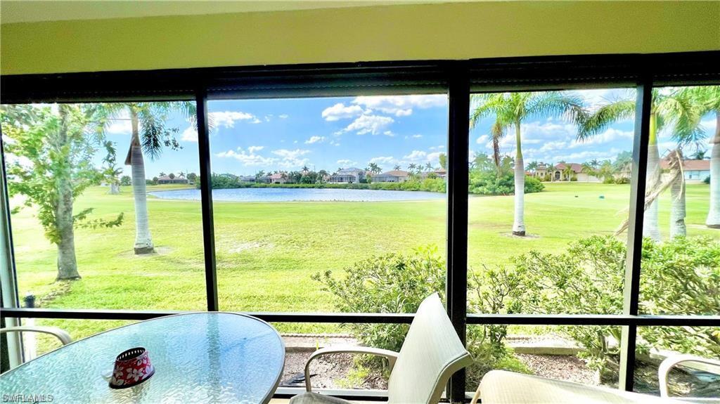 Sunroom featuring a water view
