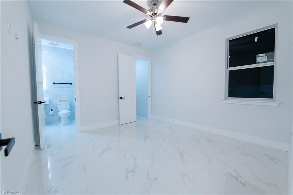 Unfurnished bedroom with ensuite bath and ceiling fan