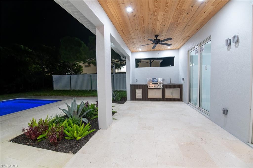 View of swimming pool with ceiling fan