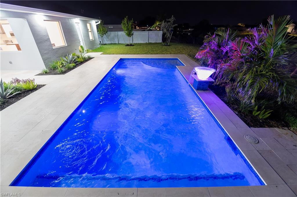 Pool at night with a patio
