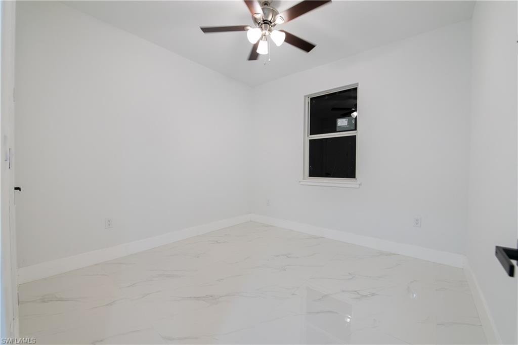 Spare room with ceiling fan