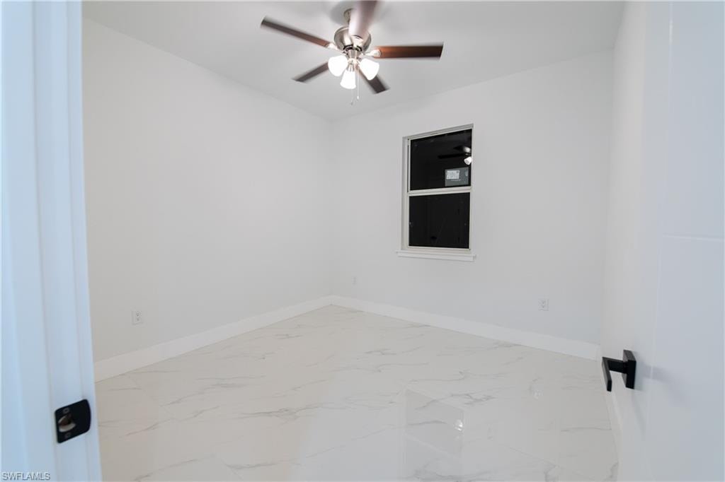 Empty room featuring ceiling fan