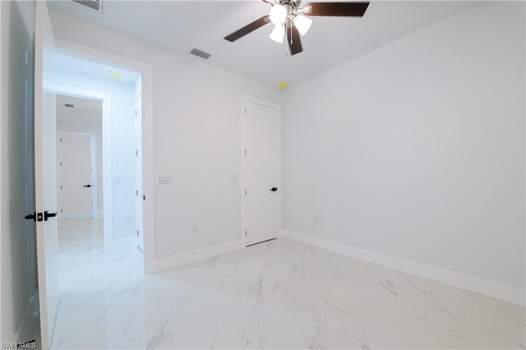Unfurnished room featuring ceiling fan