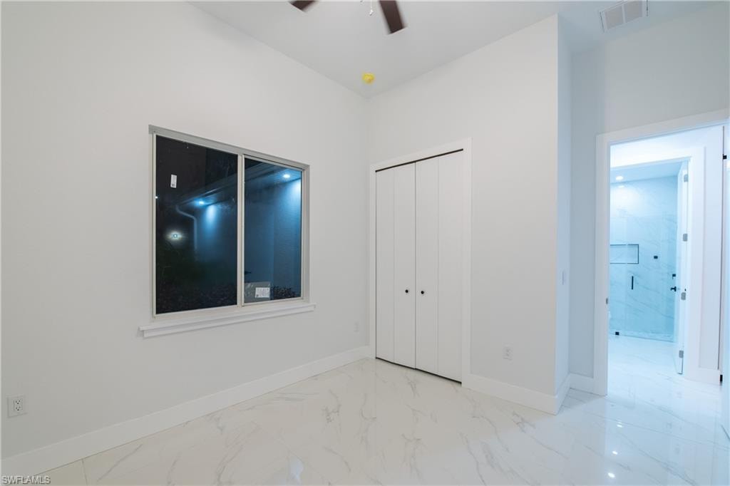 Unfurnished bedroom featuring a closet and ceiling fan