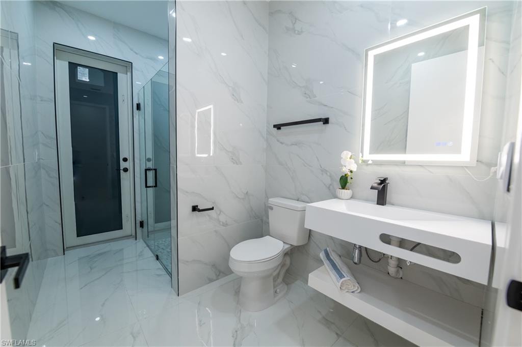 Bathroom featuring an enclosed shower and toilet
