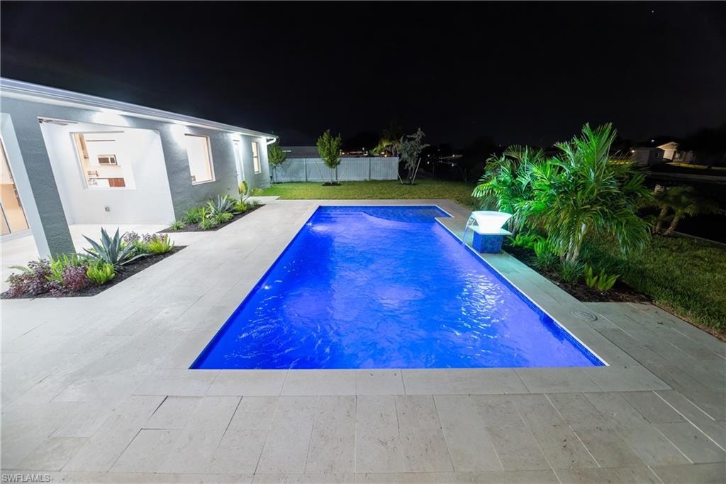 Pool at twilight with a patio
