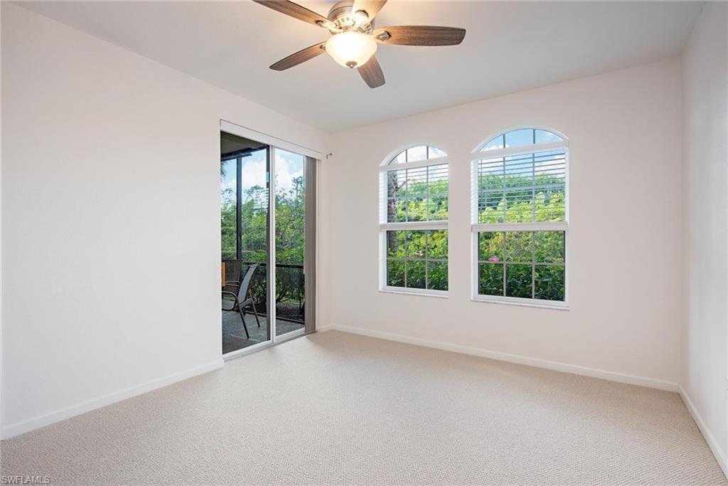 Carpeted spare room featuring ceiling fan