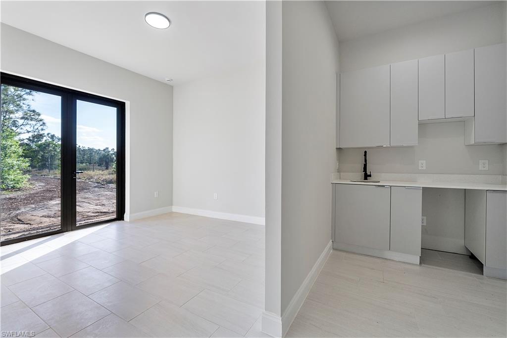 Kitchen featuring light countertops and modern cabinets