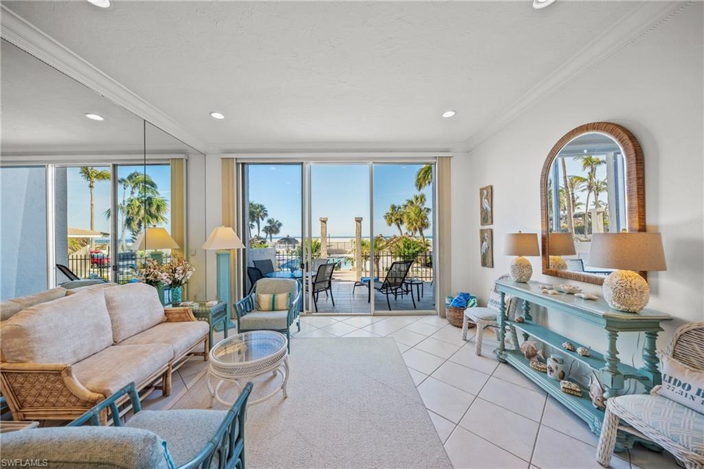 Living room featuring light tile patterned floors and ornamental molding